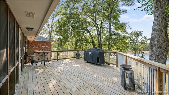 deck featuring a grill and a water view