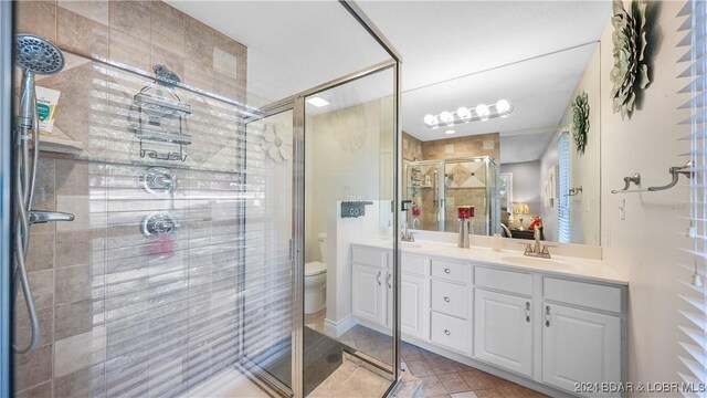 3 Willow Rd, Eldon, MO 65026 - bathroom featuring toilet, a shower stall, double vanity, and tile patterned flooring