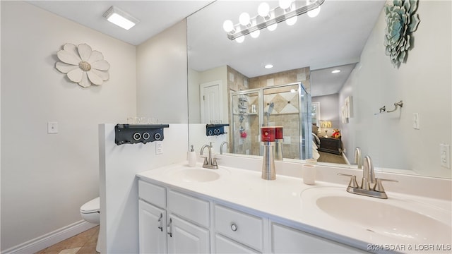 bathroom with vanity, tile patterned floors, toilet, and an enclosed shower