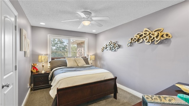 carpeted bedroom featuring a textured ceiling and ceiling fan