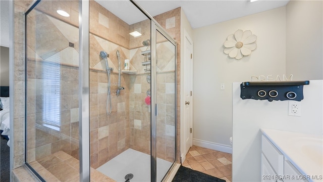 bathroom with vanity, walk in shower, and tile patterned flooring