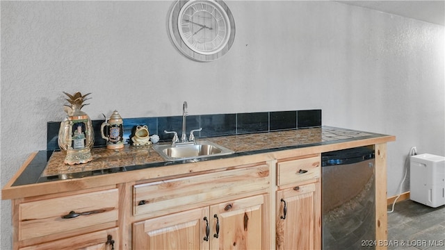 kitchen with dark hardwood / wood-style floors, sink, stainless steel dishwasher, and light brown cabinets