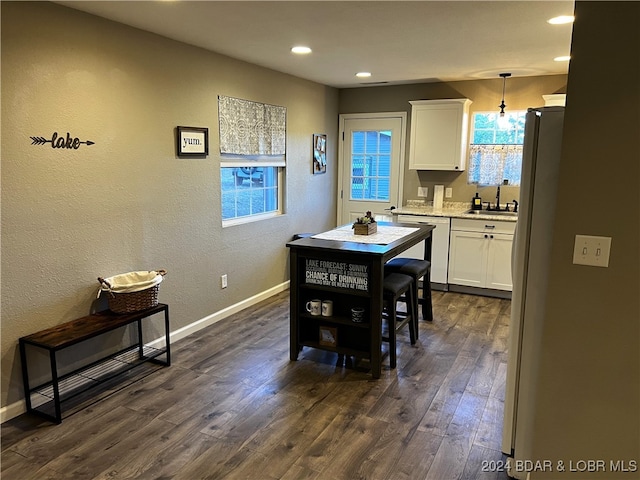 dining room with sink and dark hardwood / wood-style flooring