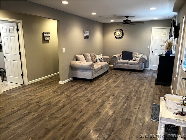 living room featuring dark hardwood / wood-style floors and ceiling fan