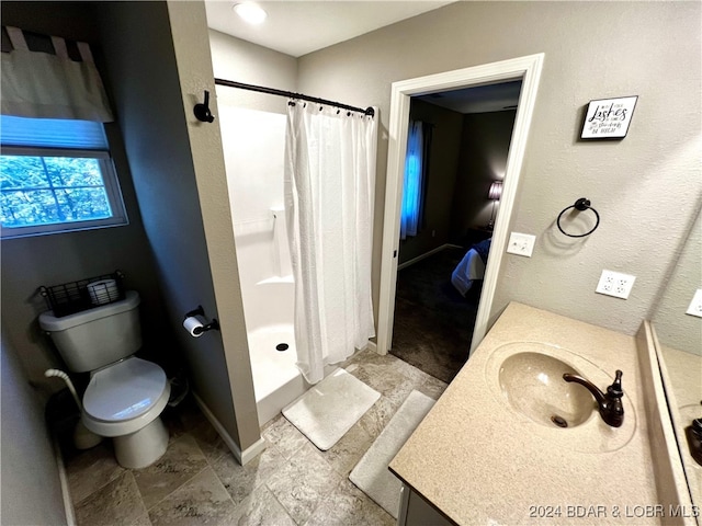 bathroom with vanity, toilet, and a shower with curtain