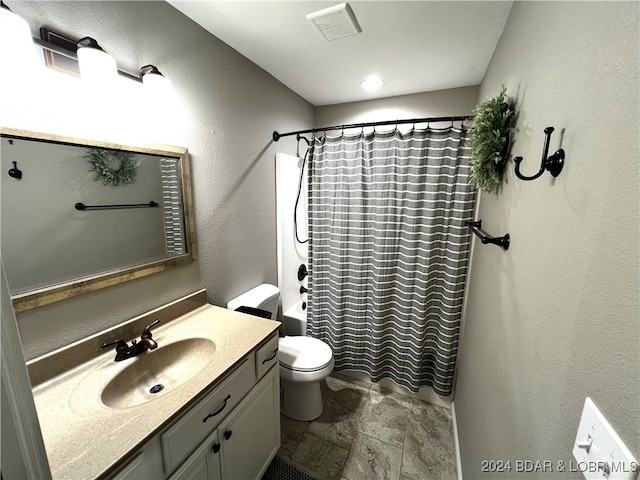 full bathroom with vanity, shower / bath combo, and toilet