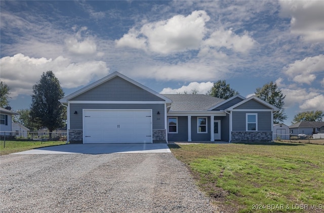 view of front of house featuring a front yard and a garage