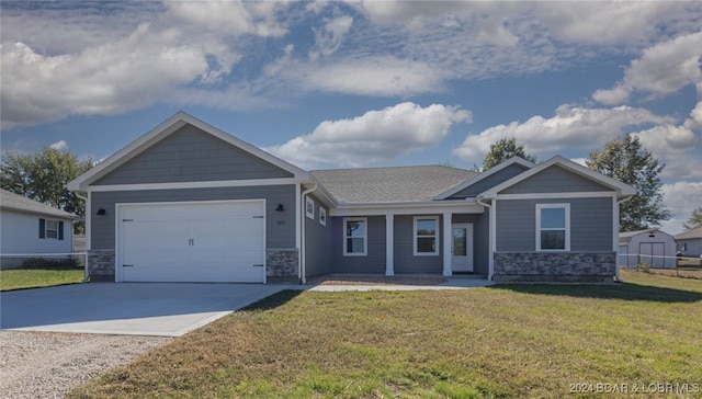 craftsman-style home with a front lawn and a garage