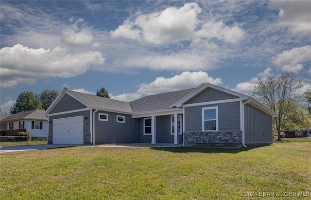 view of front of home with a front lawn and a garage