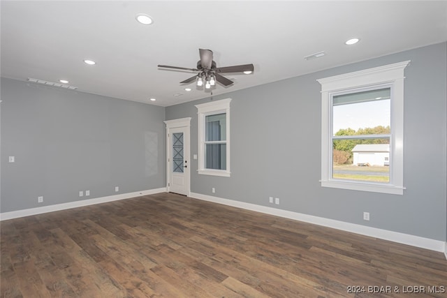 spare room featuring ceiling fan and dark hardwood / wood-style floors