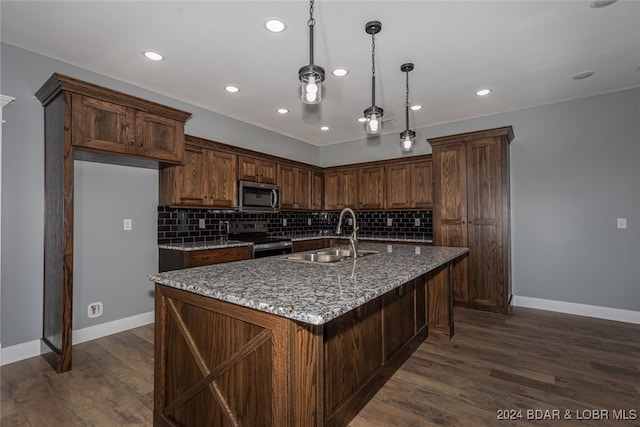 kitchen with dark hardwood / wood-style floors, backsplash, dark stone counters, sink, and appliances with stainless steel finishes