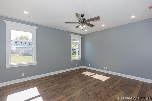 spare room with ceiling fan and dark hardwood / wood-style floors