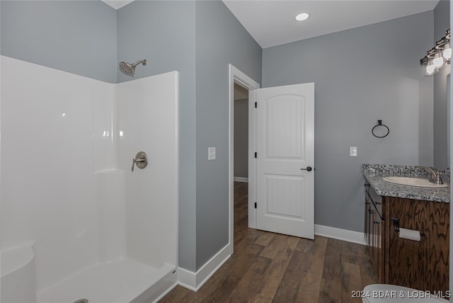 bathroom featuring vanity, hardwood / wood-style flooring, and a shower