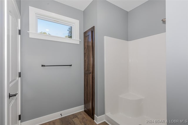 bathroom with wood-type flooring and a shower