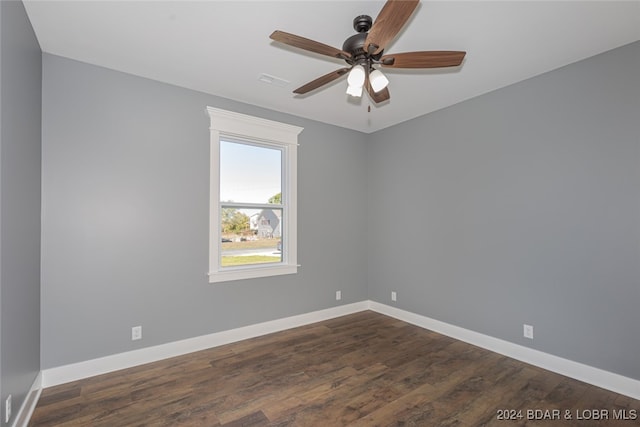 empty room with ceiling fan and dark hardwood / wood-style flooring