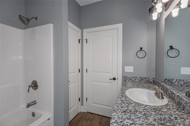 bathroom with vanity, wood-type flooring, and shower / bathtub combination