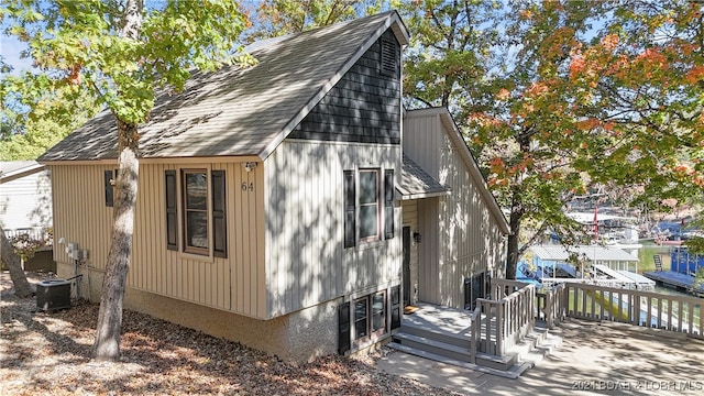 view of home's exterior with cooling unit and a deck