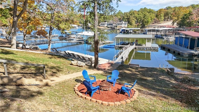 view of dock featuring a water view and a fire pit