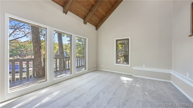 empty room featuring carpet, beam ceiling, high vaulted ceiling, and wood ceiling