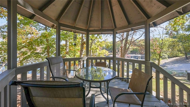 wooden terrace featuring a gazebo