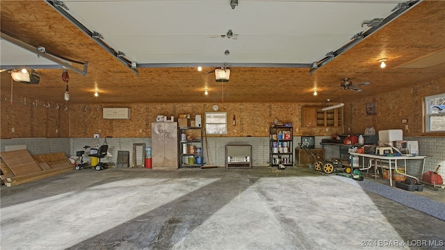 garage with a garage door opener and ceiling fan