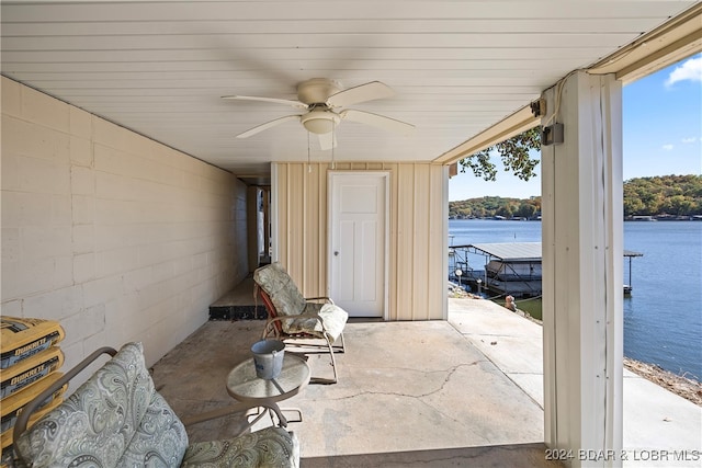 view of patio / terrace with a water view and ceiling fan