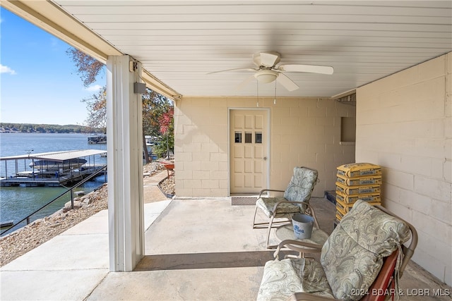 view of patio / terrace featuring a water view and ceiling fan