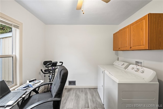 laundry room with light hardwood / wood-style flooring, a textured ceiling, washer and clothes dryer, ceiling fan, and cabinets