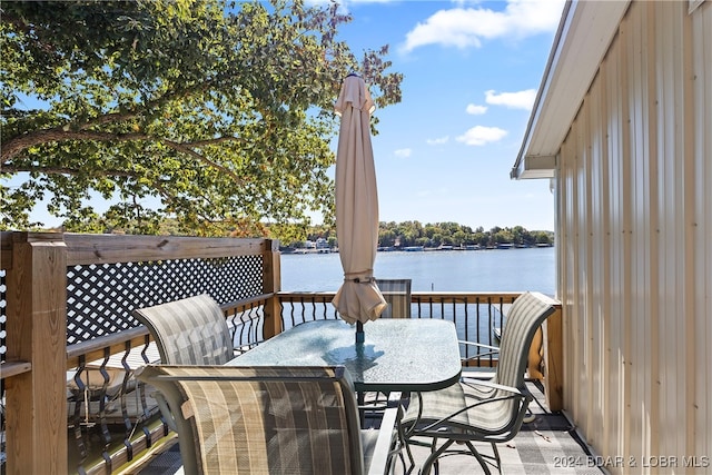 wooden terrace featuring a water view