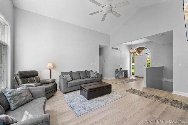 living room with light hardwood / wood-style flooring, high vaulted ceiling, and ceiling fan