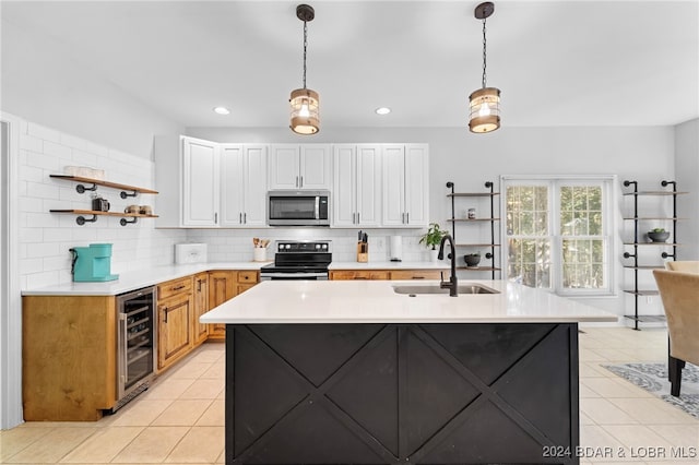 kitchen with appliances with stainless steel finishes, sink, hanging light fixtures, white cabinets, and wine cooler