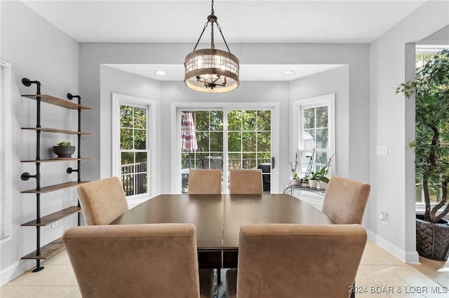 tiled dining area with a chandelier