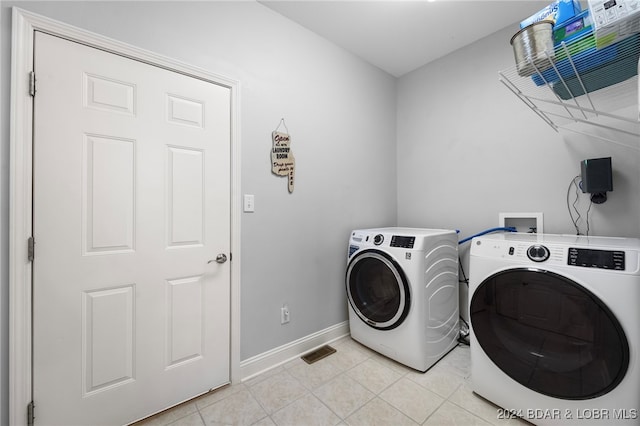 washroom with light tile patterned floors and separate washer and dryer