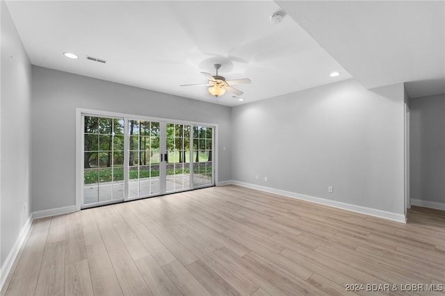 spare room with light wood-type flooring and ceiling fan