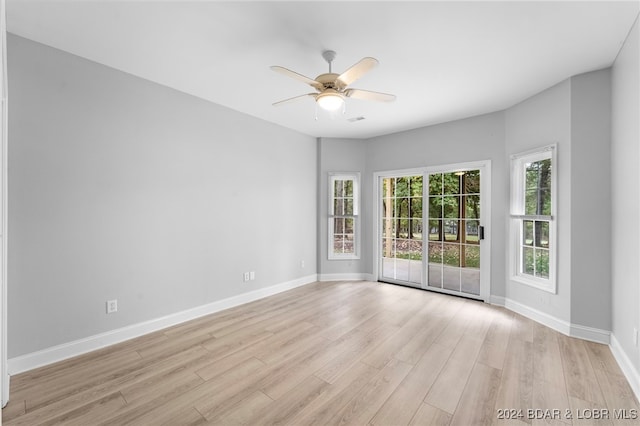 spare room with light wood-type flooring and ceiling fan