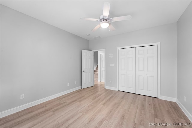 unfurnished bedroom featuring a closet, ceiling fan, and light wood-type flooring