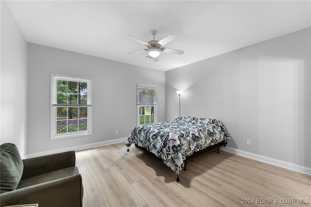 bedroom with light wood-type flooring and ceiling fan