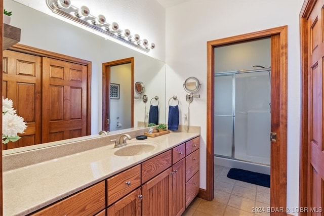 bathroom featuring vanity, walk in shower, and tile patterned flooring