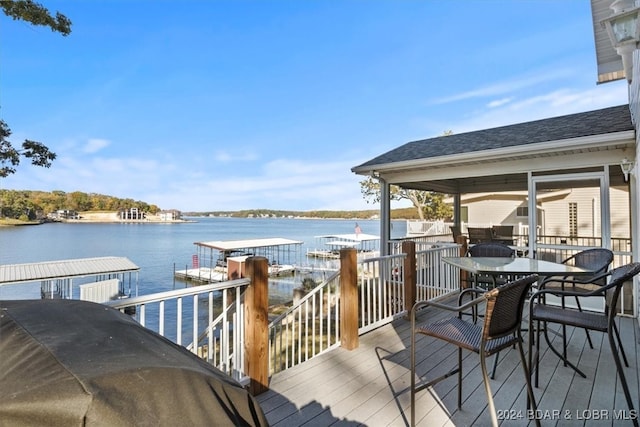 wooden terrace featuring a water view