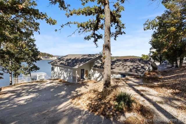 view of front of home with a water view