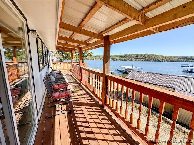 wooden terrace featuring a water view