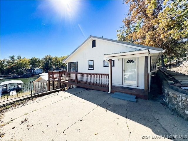 rear view of property with fence and a deck