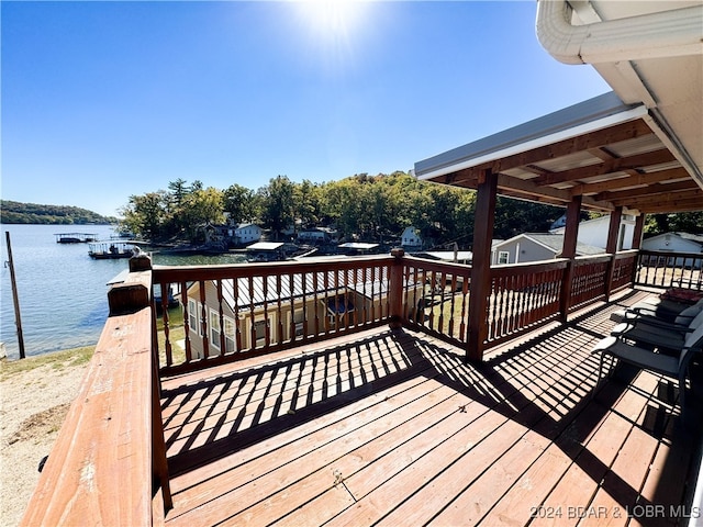 wooden deck featuring a water view