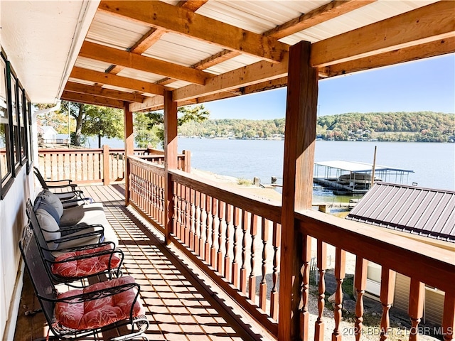 wooden terrace featuring a water view