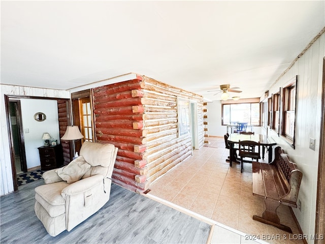 living area featuring a ceiling fan and wood finished floors