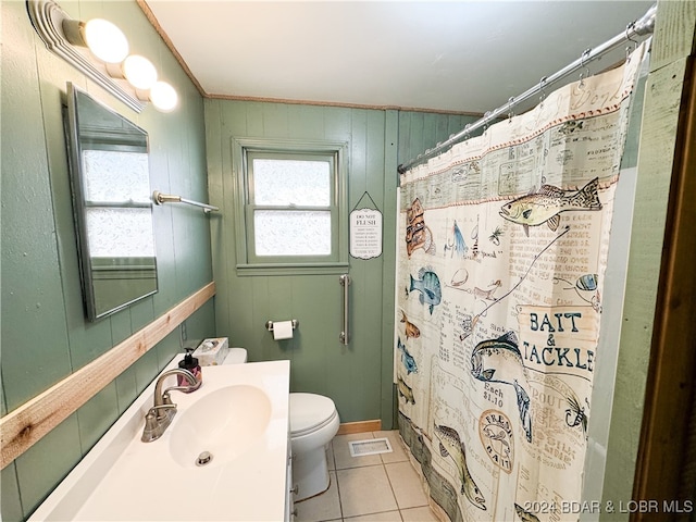 bathroom featuring wooden walls, a shower with shower curtain, toilet, tile patterned flooring, and vanity