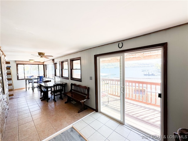 dining room with light tile patterned floors and a ceiling fan