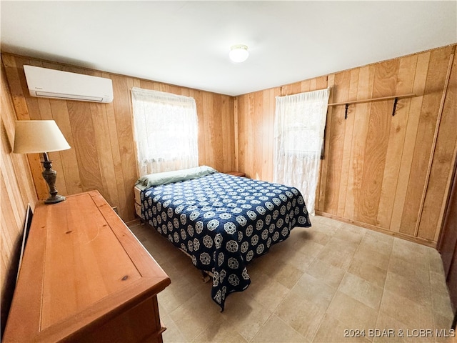 bedroom with wood walls and a wall mounted AC