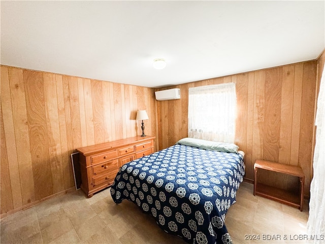 bedroom with an AC wall unit and wood walls