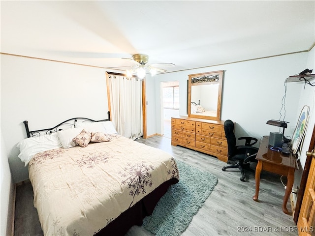 bedroom with light wood-style floors and a ceiling fan